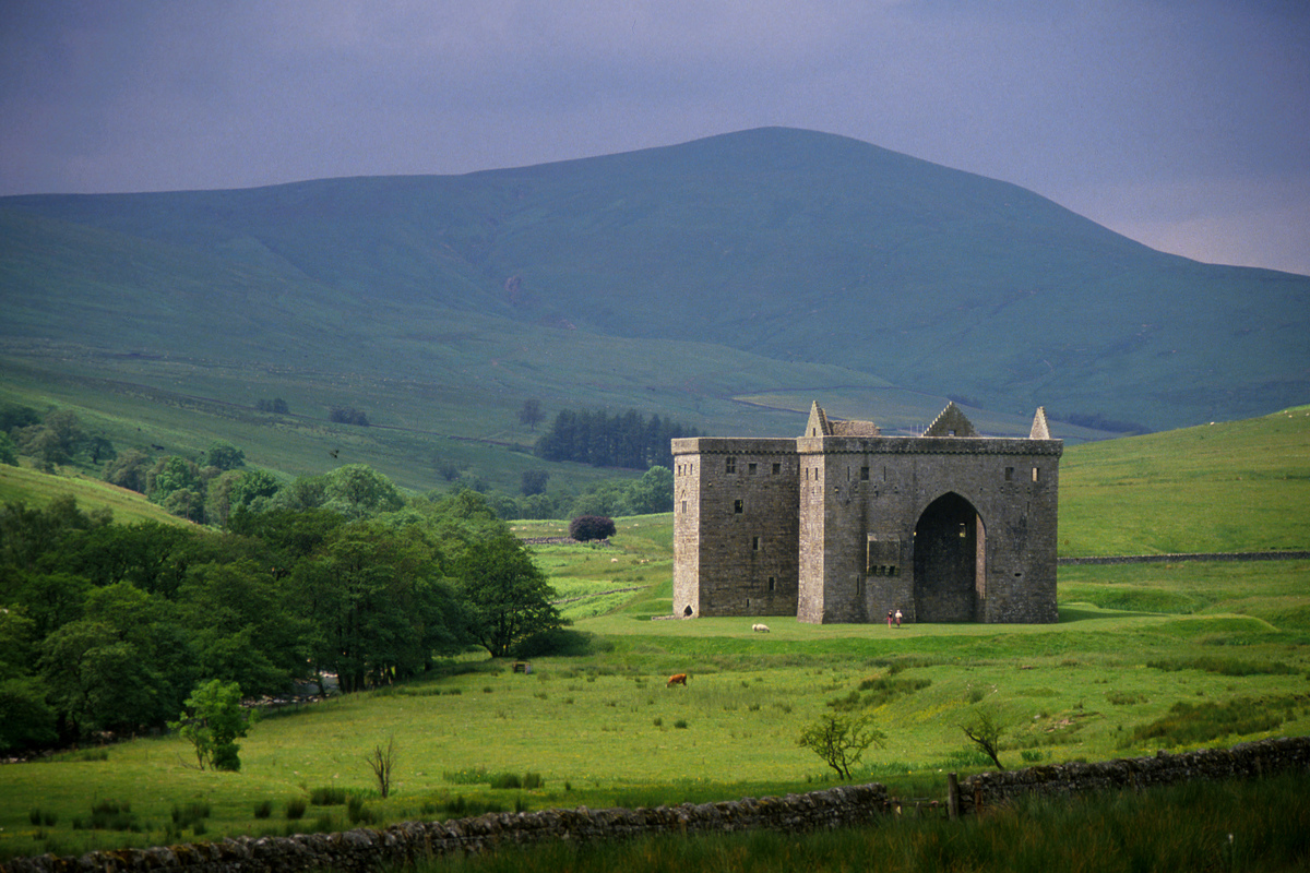 LOOKING ACROSS MOORLAND TO THE REMAINS OF HERMITAGE CASTLE- DATING FROM THE 13C ALTHOUGH THE KEEP AND CORNER TOWERS VISIBLE TODAY DATE MAINLY FROM THE 14C, NORTH OF NEWCASTLETON, SCOTTISH BORDERS.
PIC: P.TOMKINS/VisitScotland